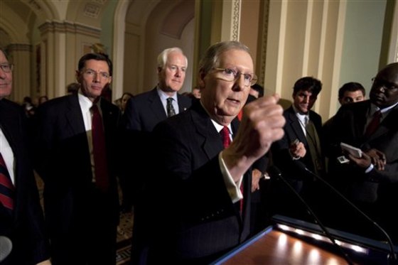Sens. John Barrasso, R-Wyo., and John Cornyn, R-Texas, listen as Senate Minority Leader Mitch McConnell speaks to reporters after the weekly caucus luncheons in Washington on Tuesday. McConnell says he's ready to work with Obama on Social Security and other tough issues.
